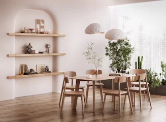 a room with a table, chairs, shelves and a potted plant