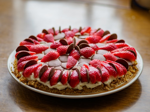 A selection of strawberry tarts arranged on a white plate.