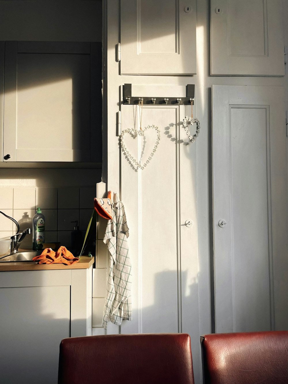 a kitchen area with a sink, stove, and cabinets