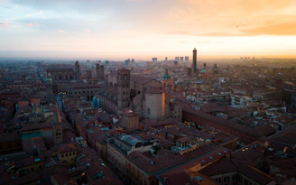 View from one of the terraces overlooking the rooftops of Granada's historic center at sunset.