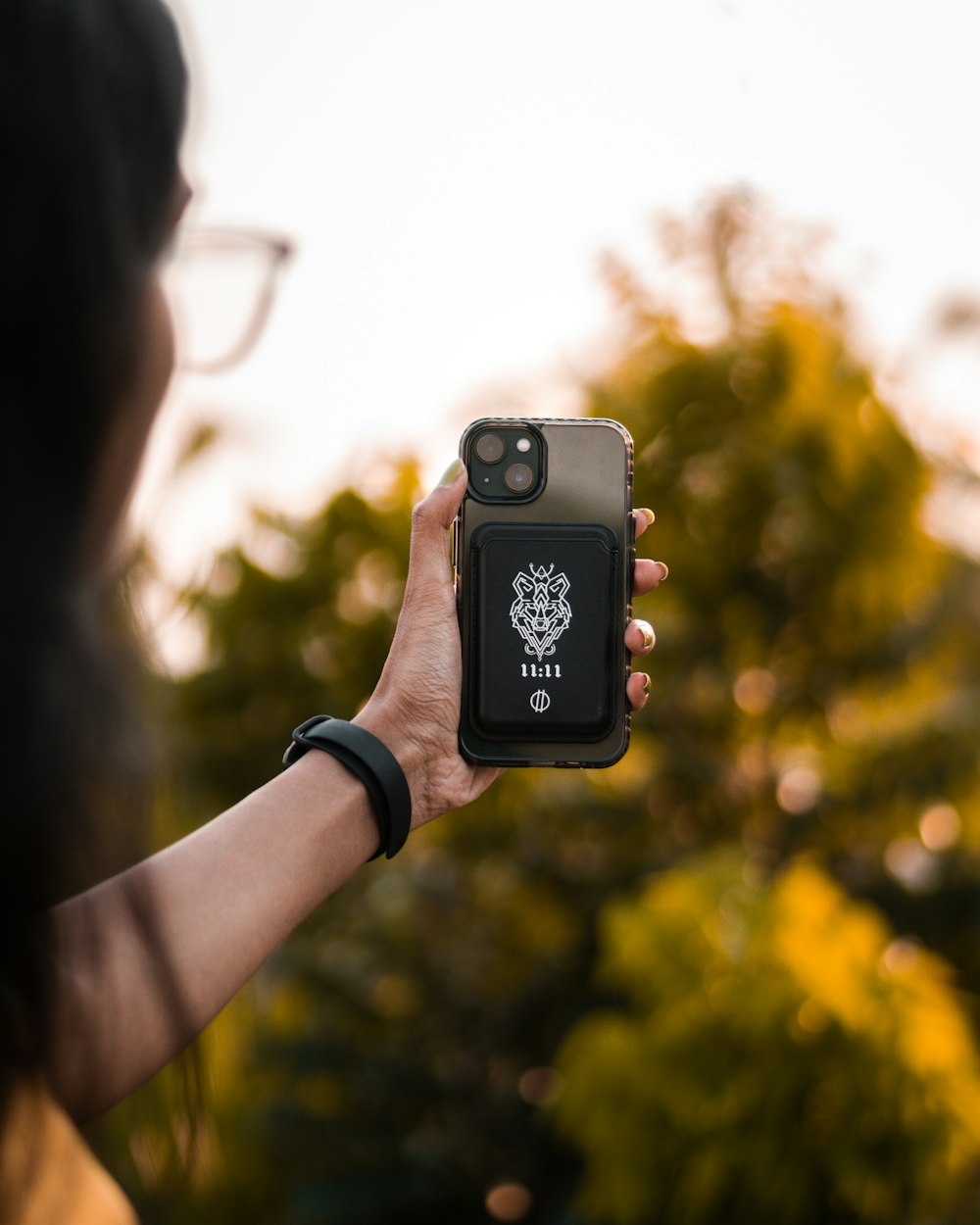 a woman holding up a cell phone in her hand