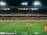A lively youth soccer match captured under bright stadium lights, with families cheering in the stands.