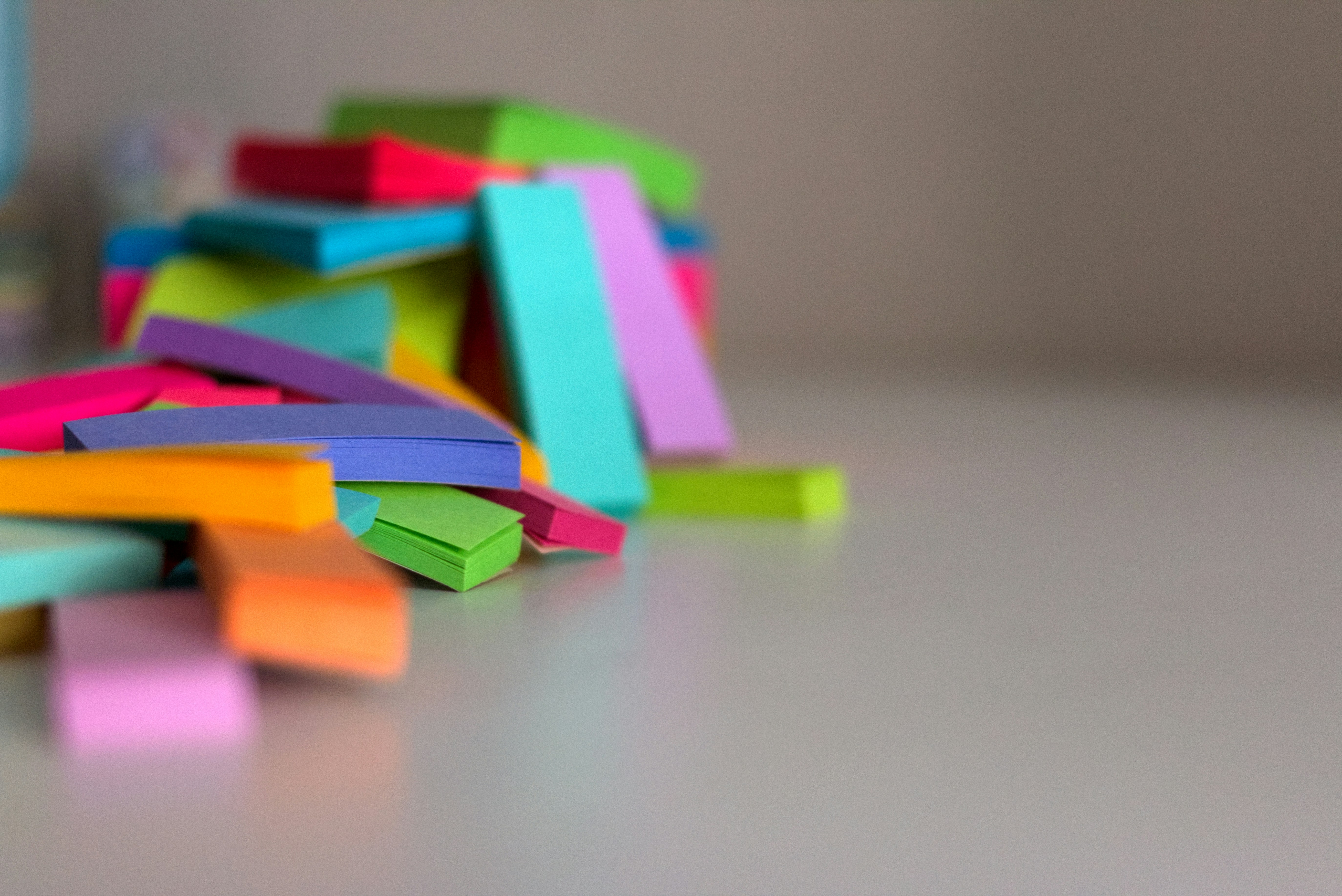 a pile of colored post it notes on a table