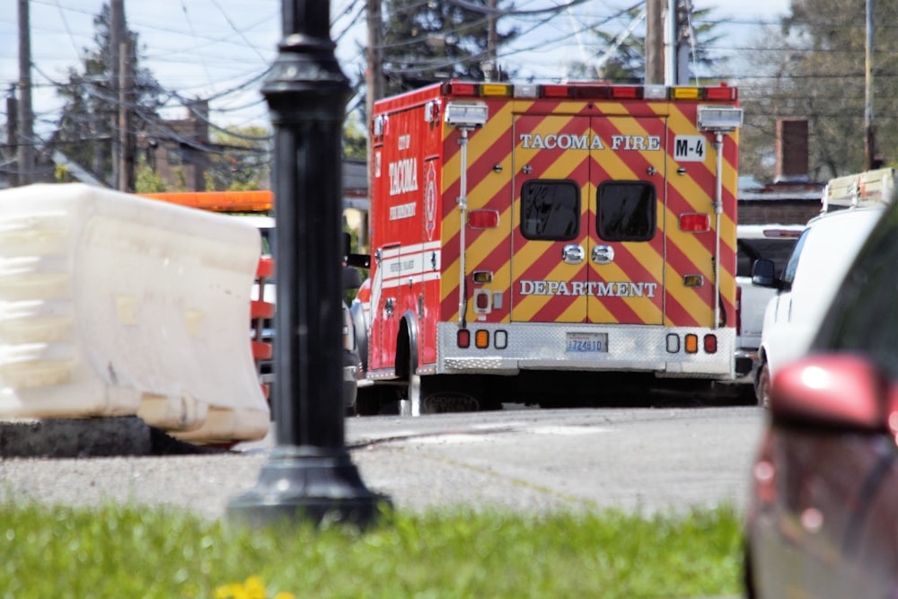 a red and yellow emergency truck parked in a parking lot