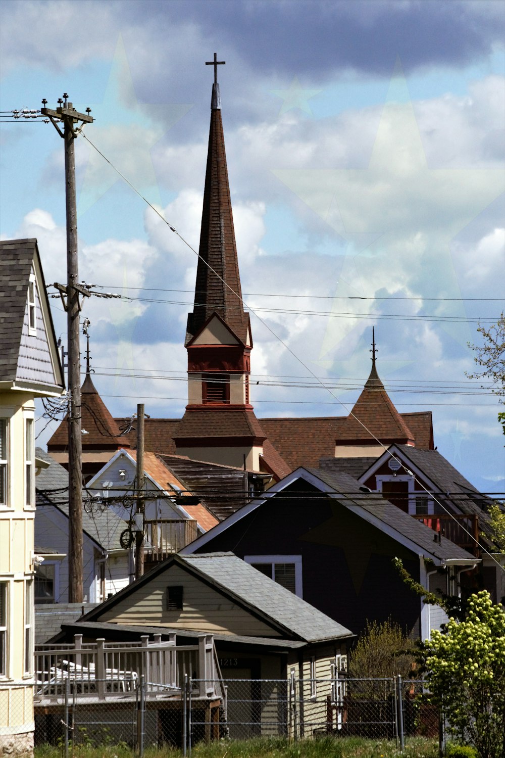 a row of houses with a church steeple in the background