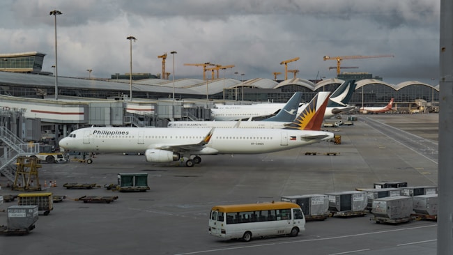 a couple of airplanes parked at an airport