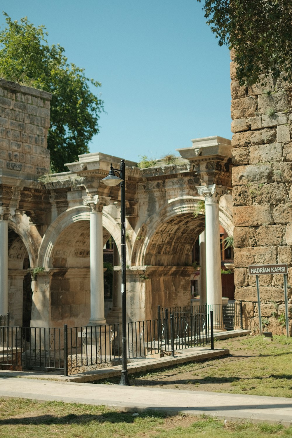 a stone building with pillars and arches on the side of it