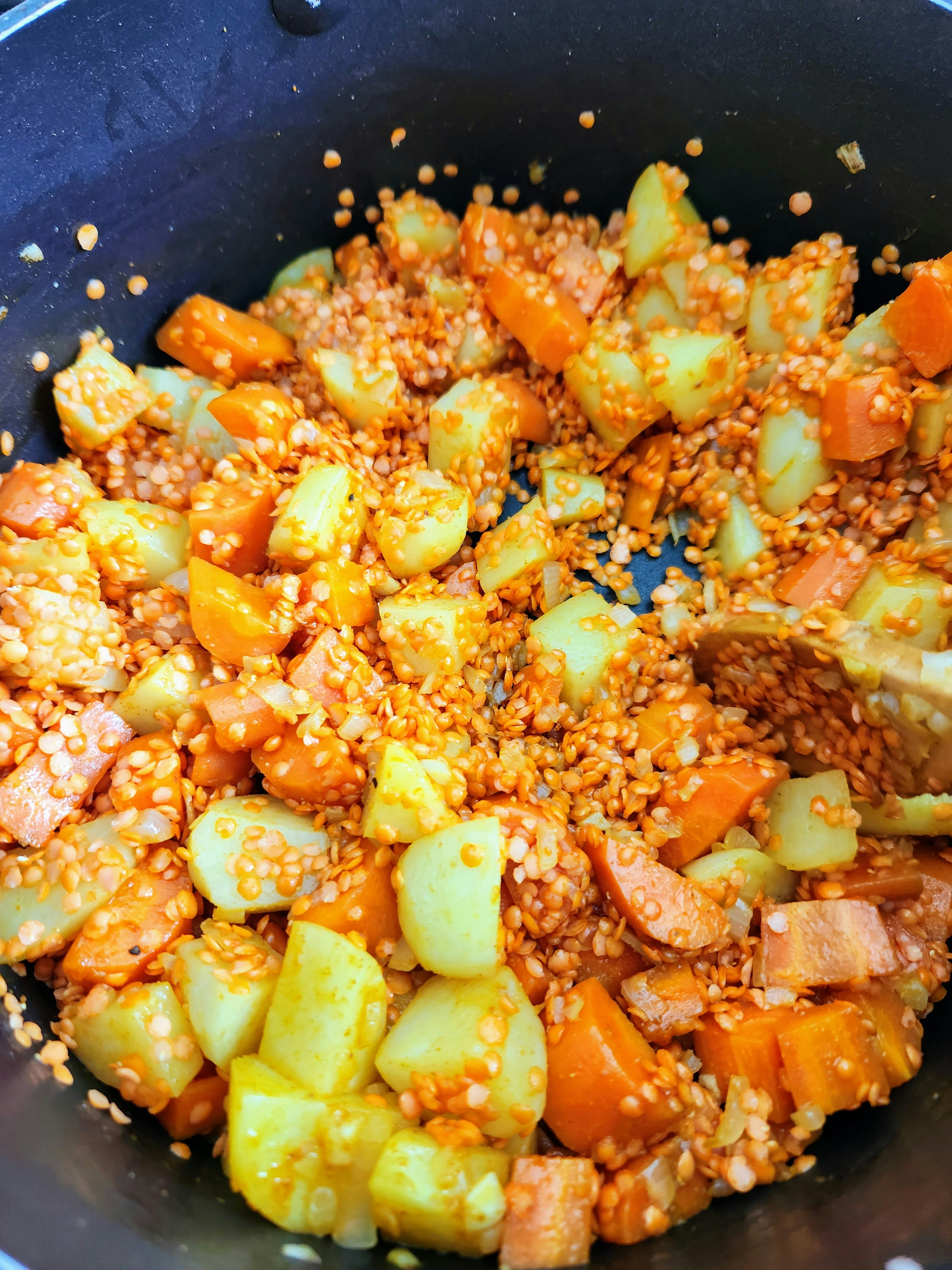 a pan filled with rice and vegetables on top of a stove