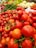 Fresh vegetables and fruits neatly arranged in a vibrant market setting.