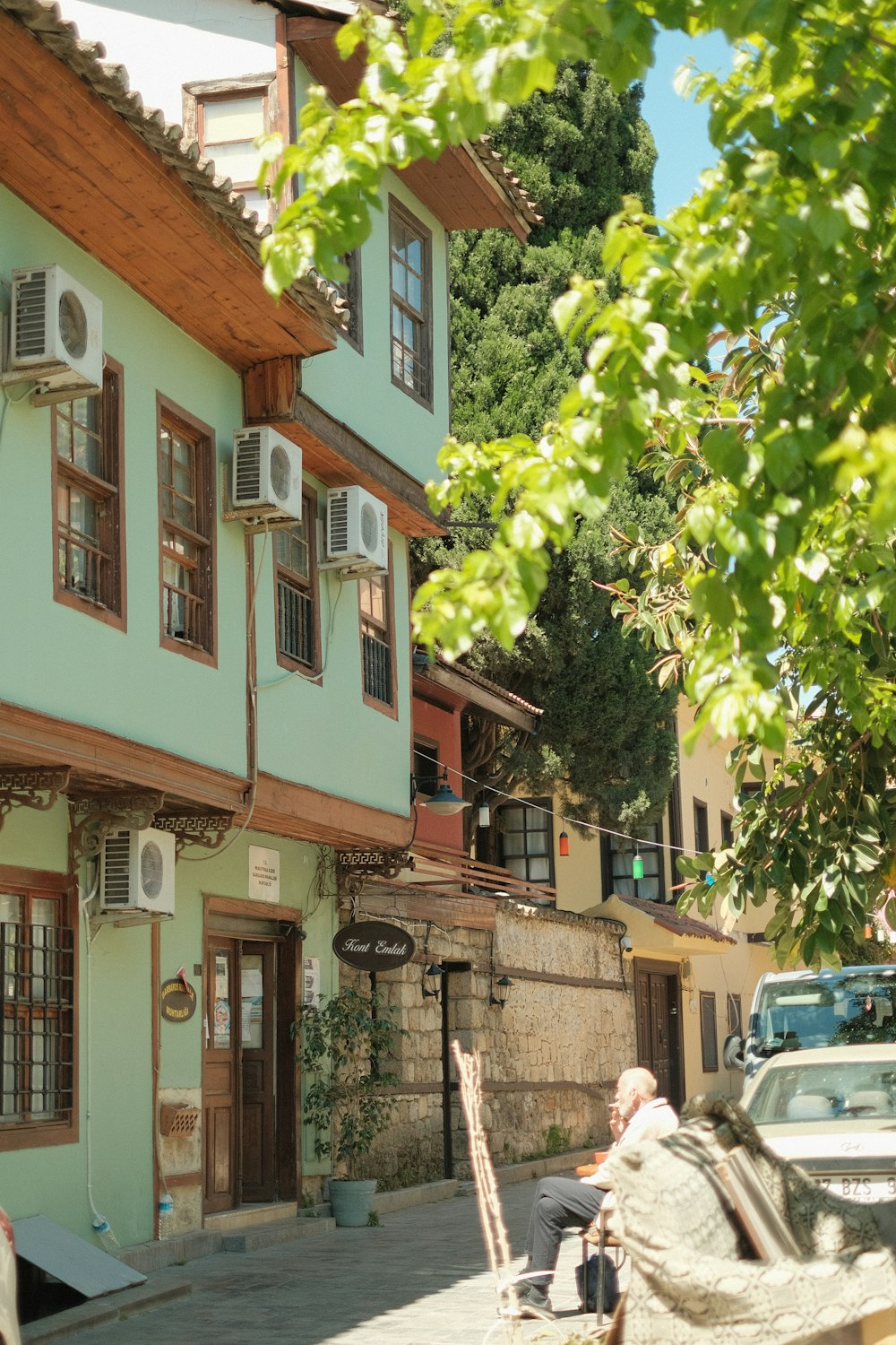 a man sitting on a bench in front of a building