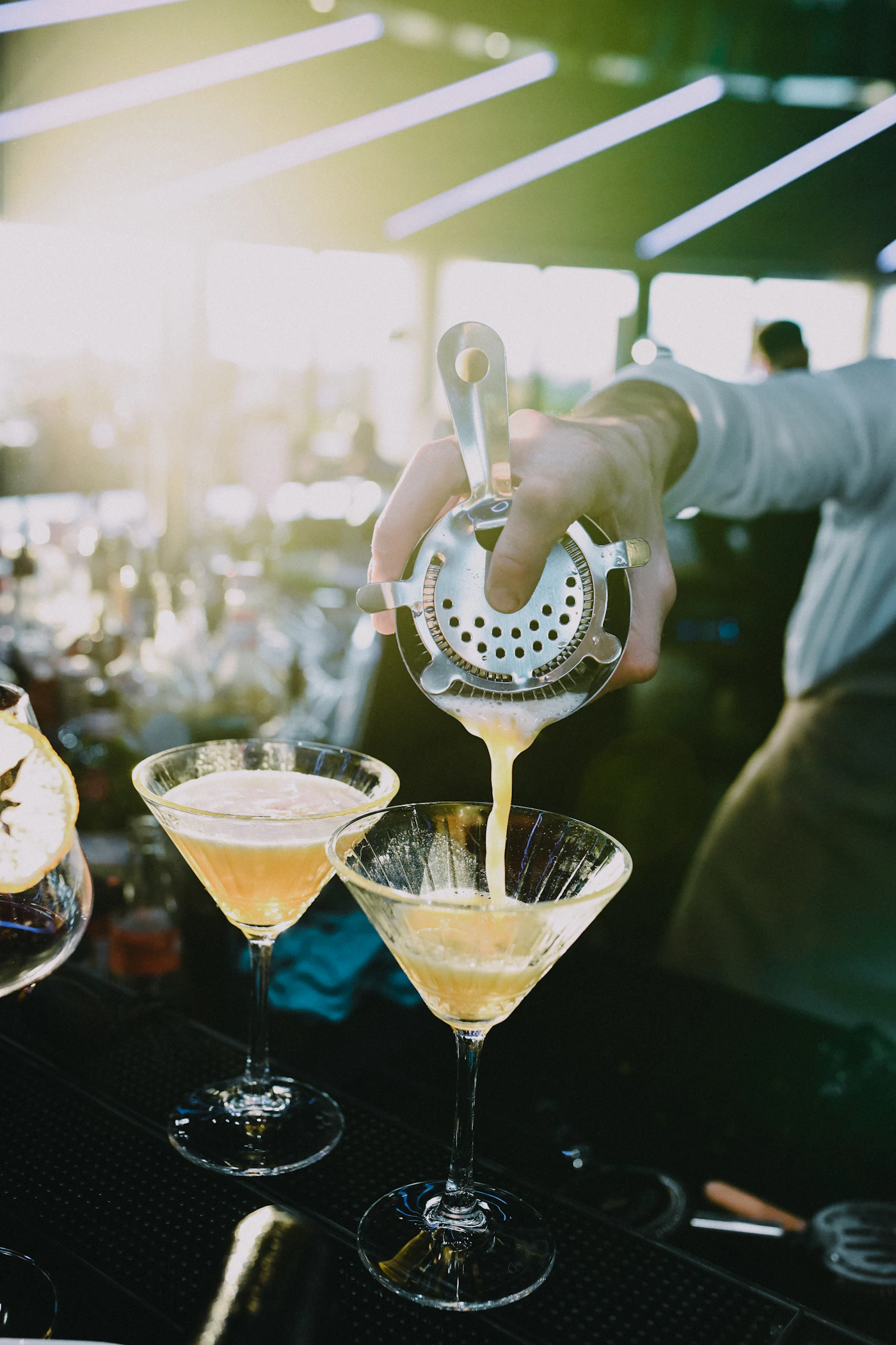 Bartender pouring elegant martinis