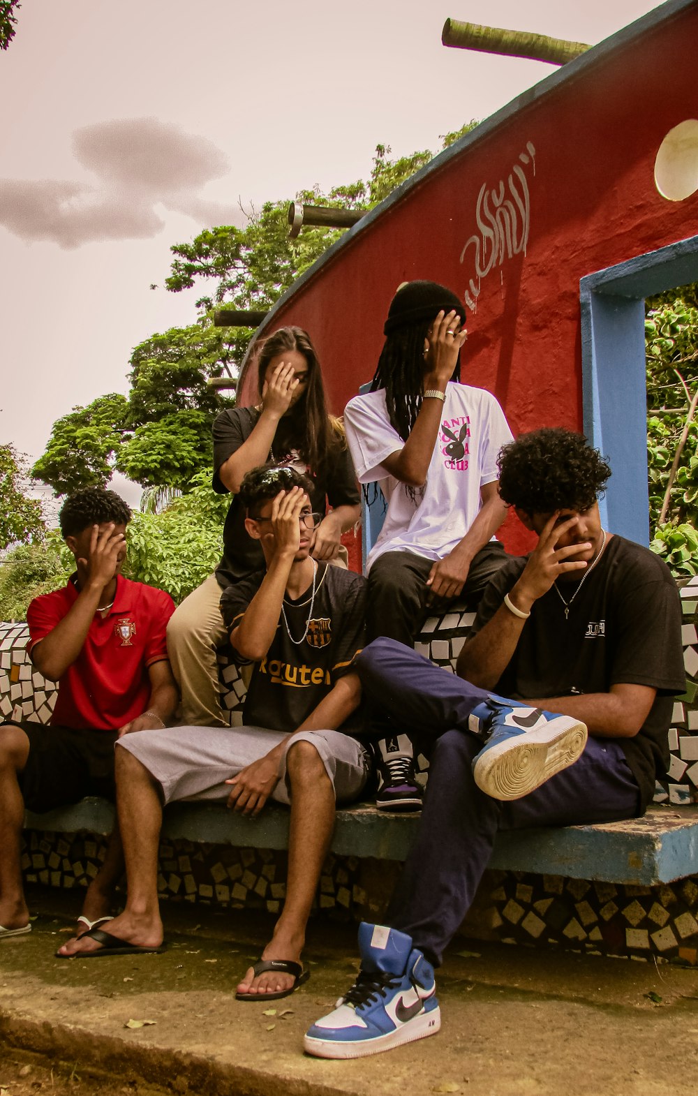 a group of young people sitting on a bench