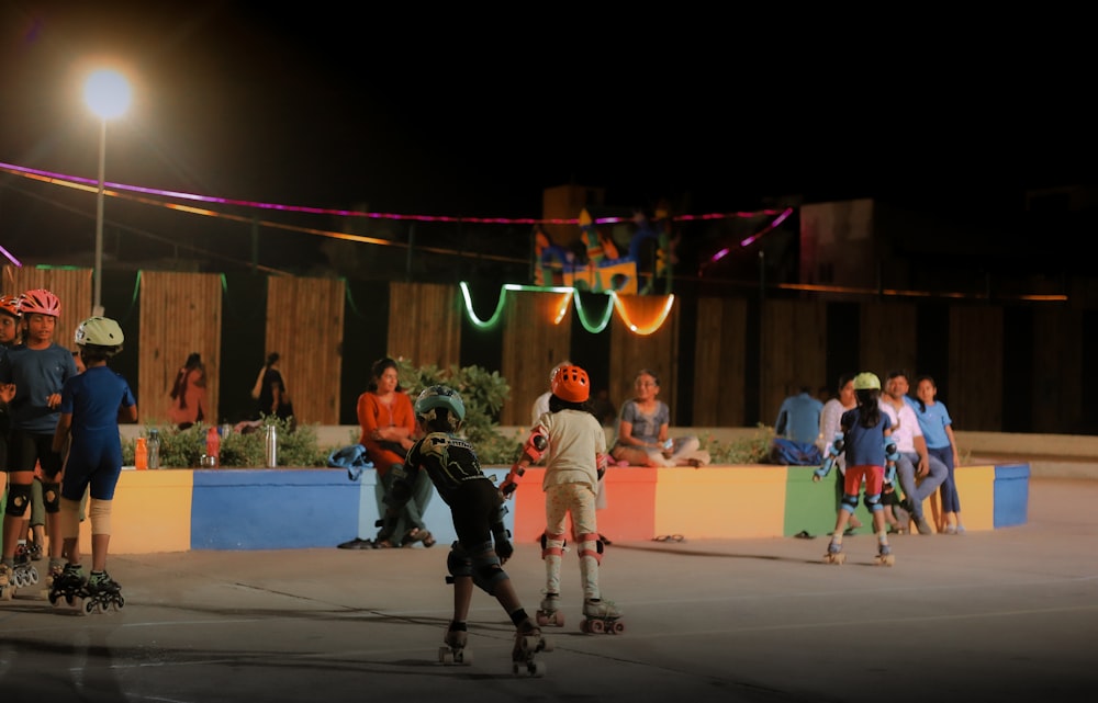 a group of people riding skateboards down a street