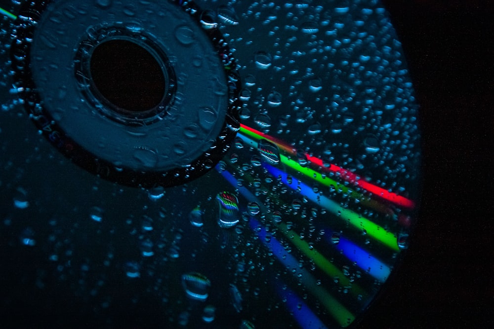 a close up of a cd with water droplets on it