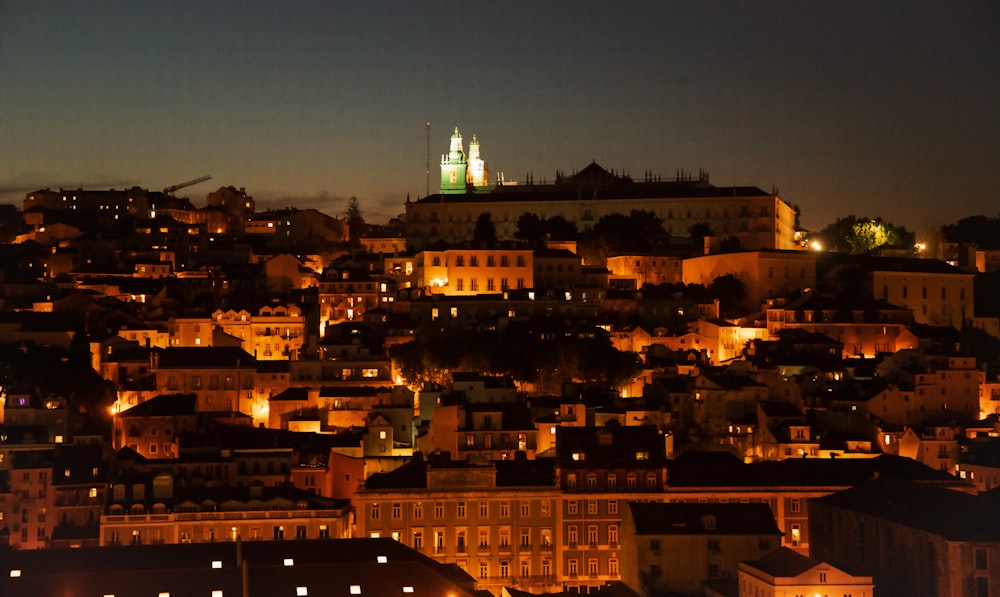 a view of a city at night from a hill