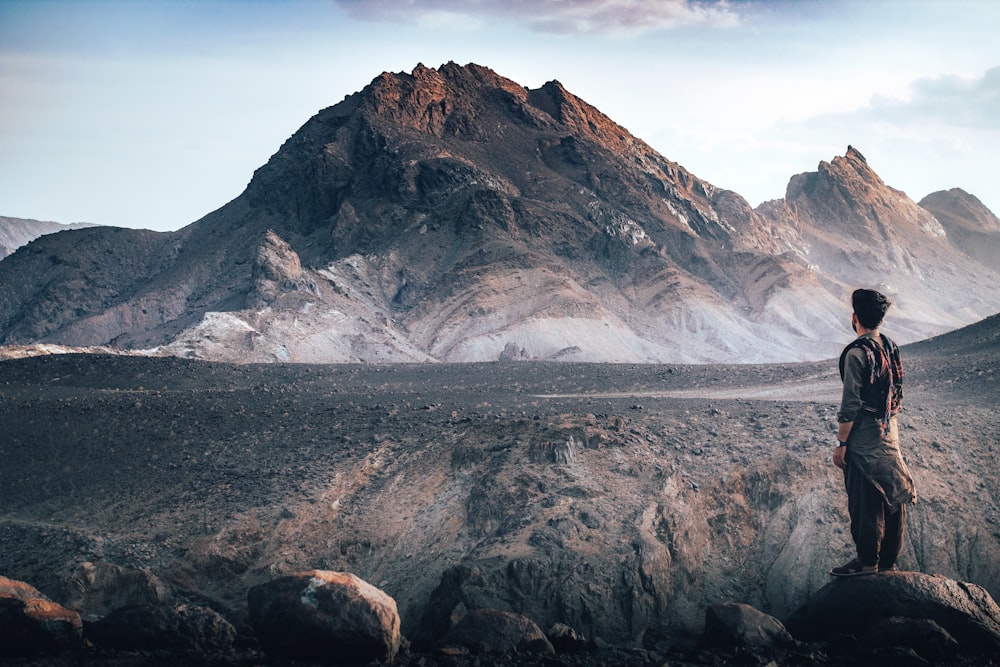 a man standing on top of a rocky mountain