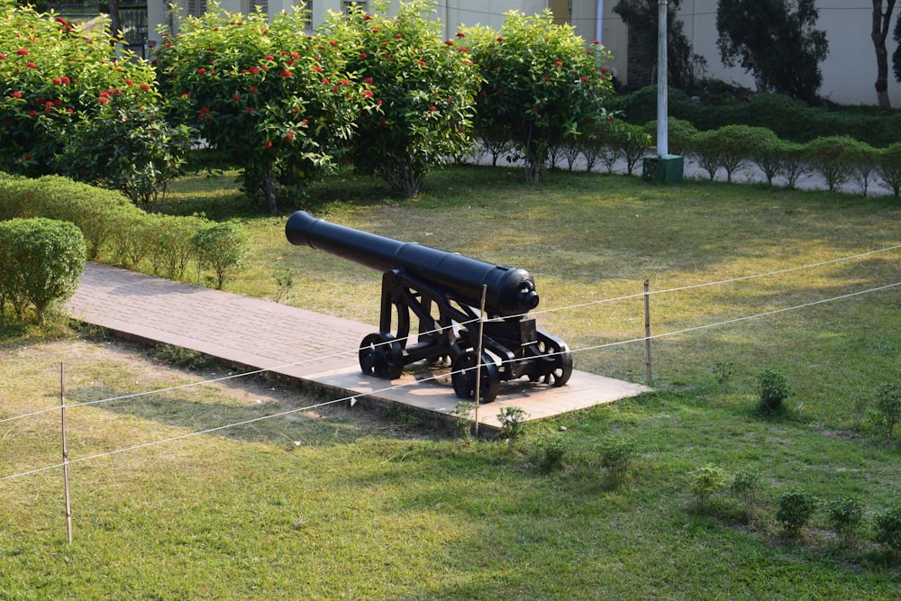 a large black cannon sitting on top of a wooden platform