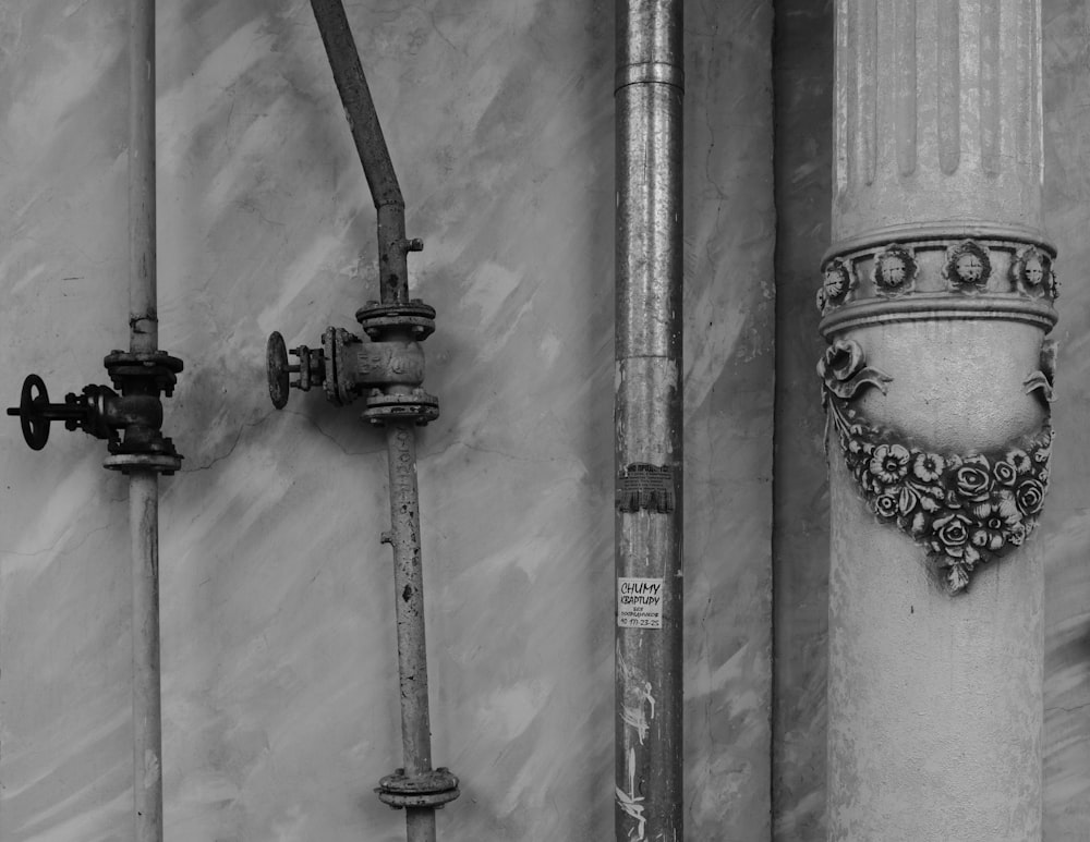 a black and white photo of pipes and valves