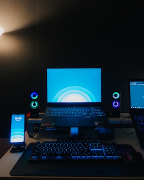 Creative shot of electronic devices glowing with blue light.