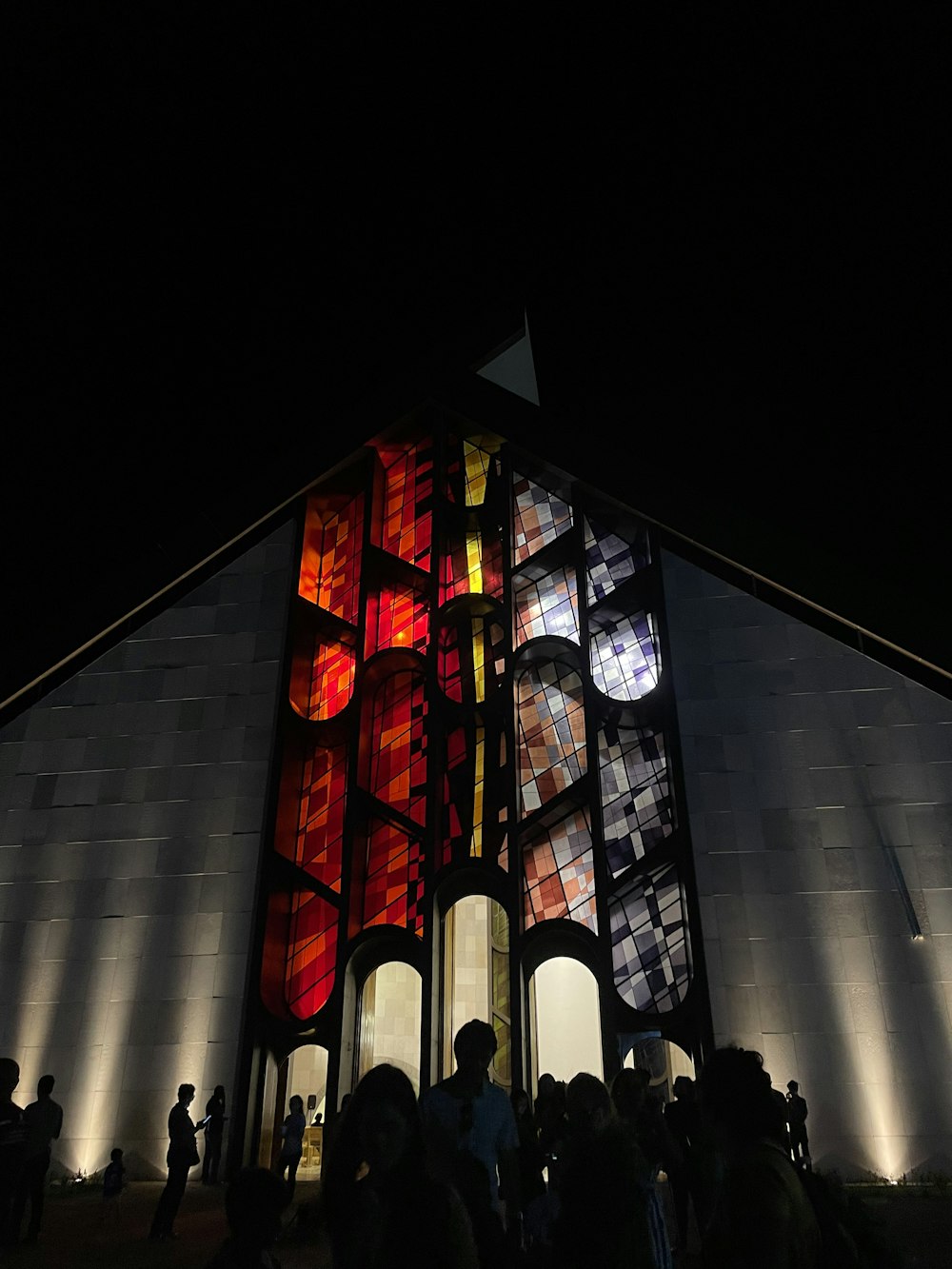 a group of people standing in front of a building