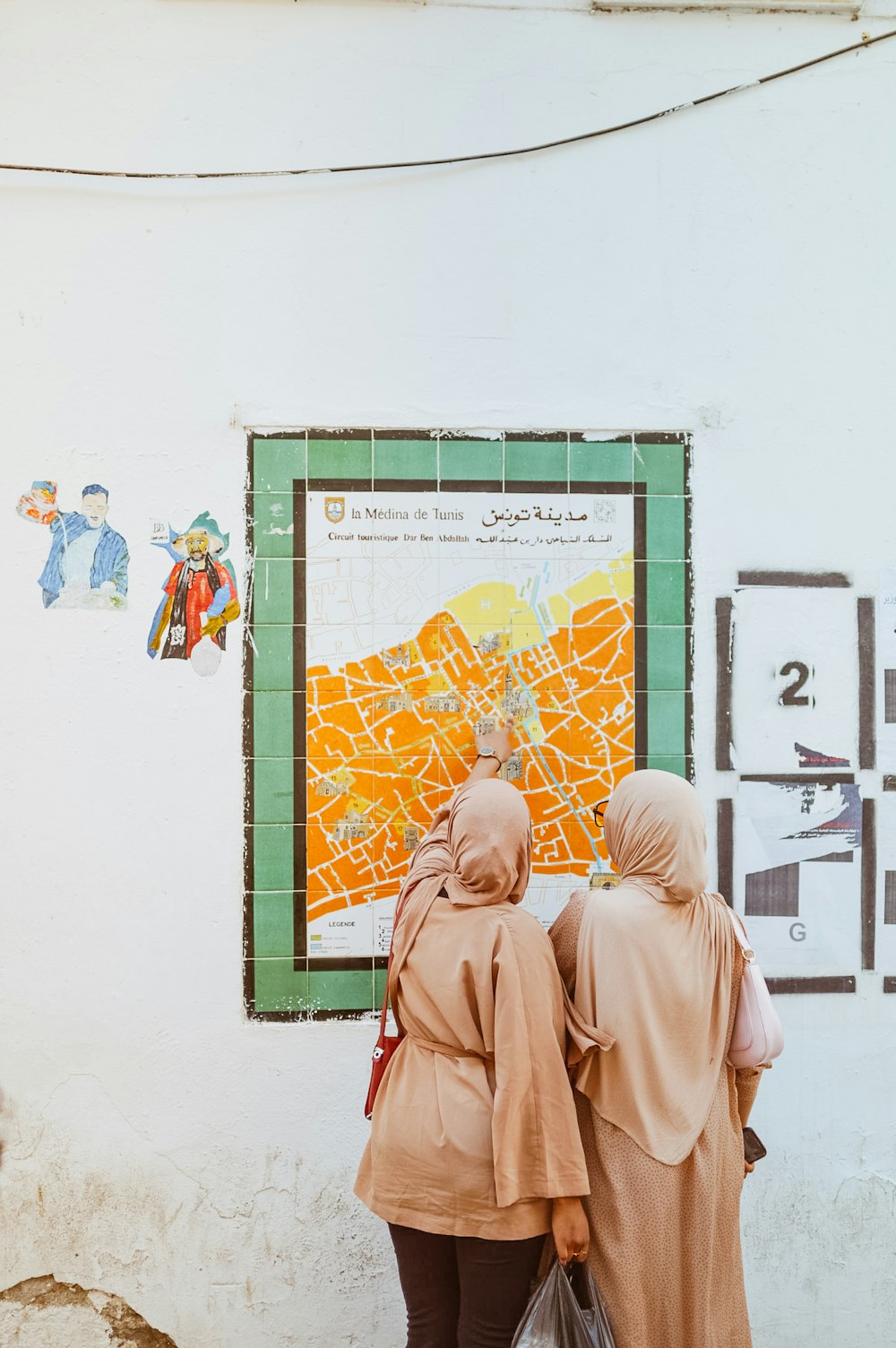 two women looking at a map on a wall
