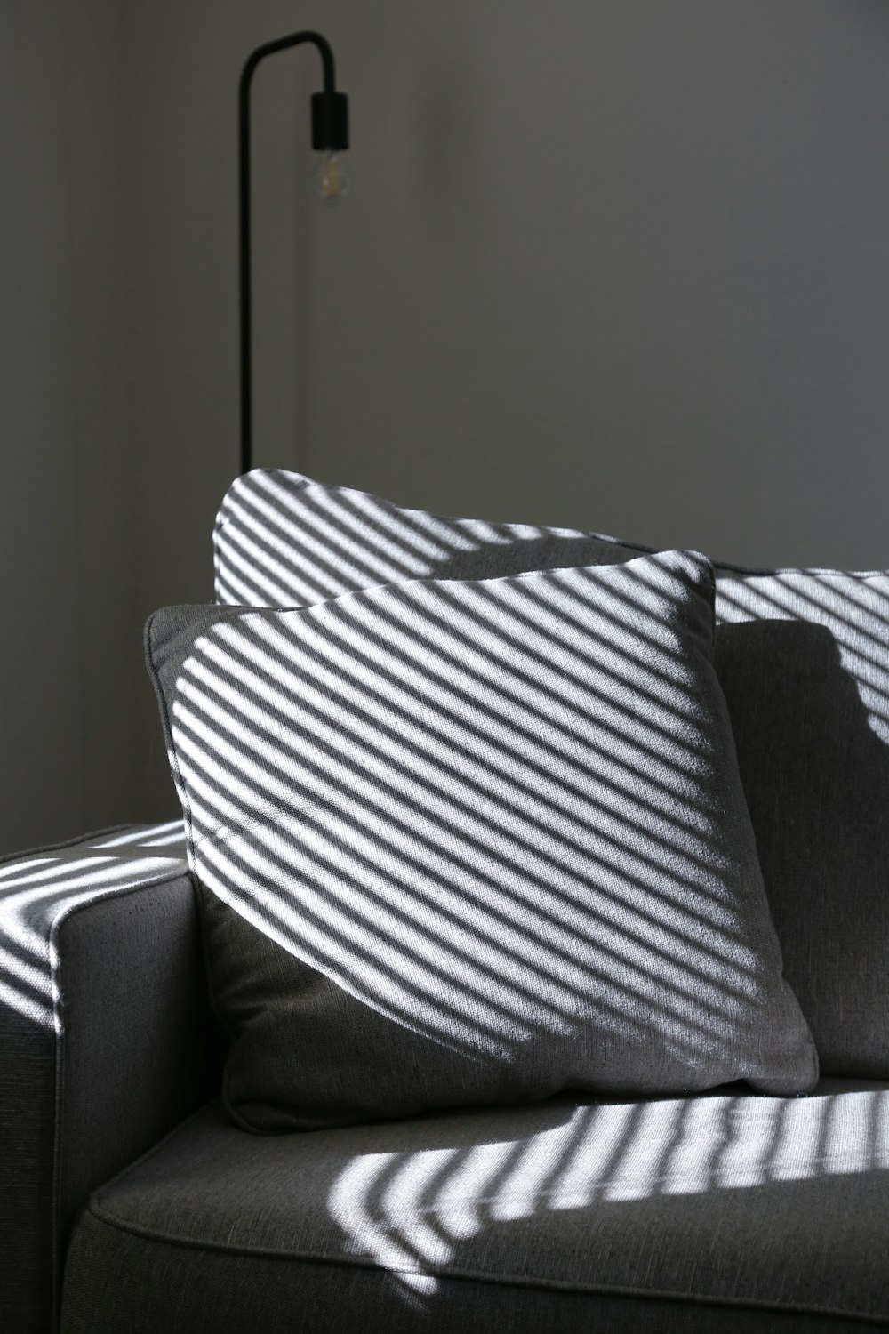 a black and white couch with a striped pillow