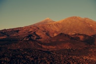 A panoramic landscape photo taken during golden hour, rich with warm tones.