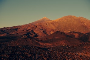 A panoramic view of rugged mountain ridges bathed in golden sunset light