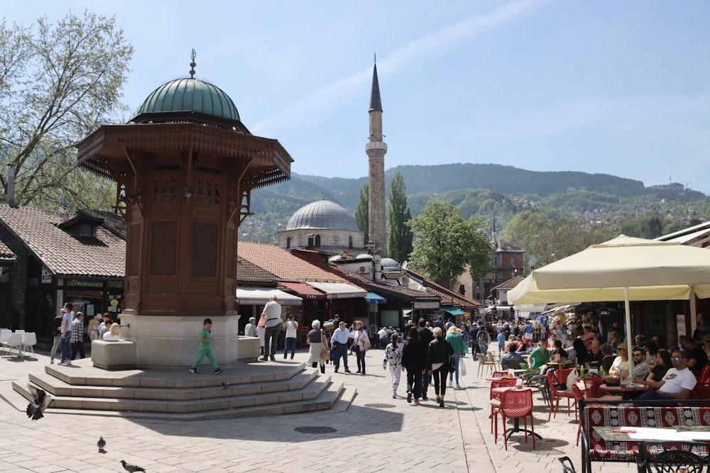 a group of people walking around a town square