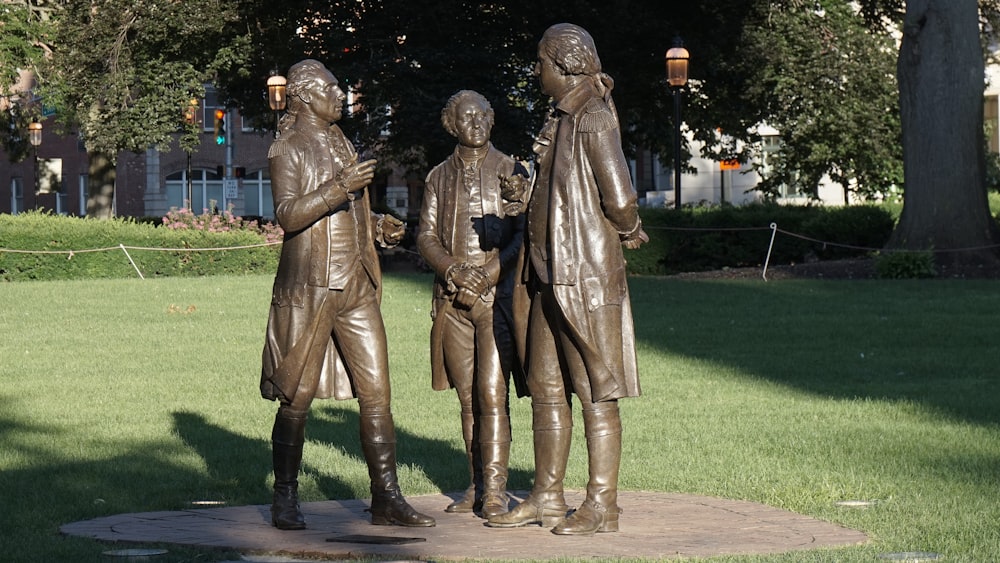 a statue of three men standing next to each other