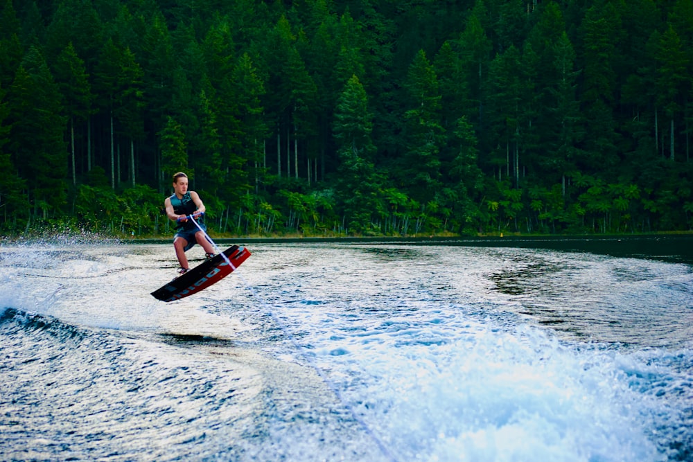 a man riding a wake board on top of a body of water