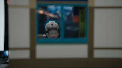 Close-up of cute figurines and trendy accessories spilling out of a gashapon capsule.