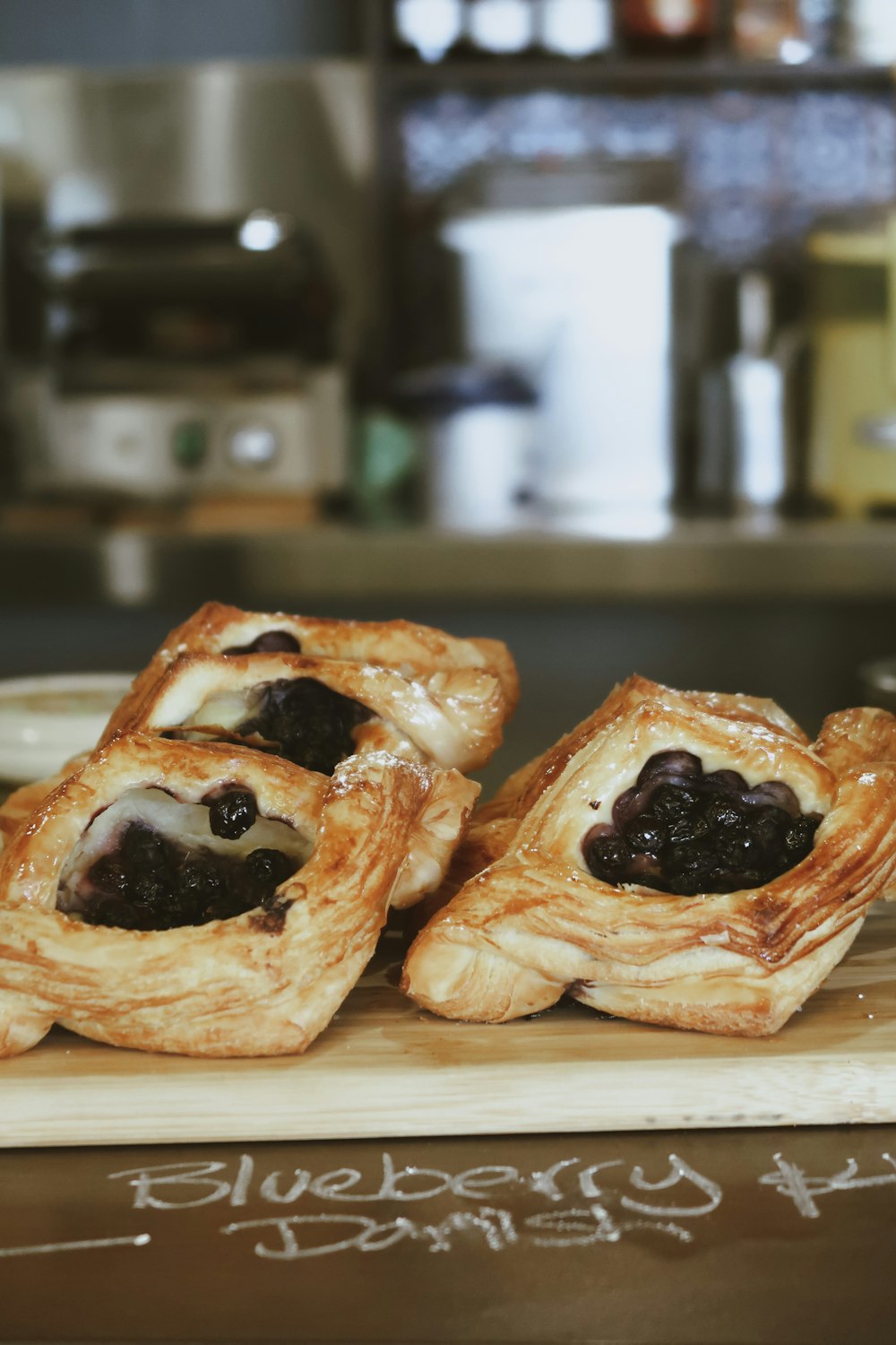 a couple of pastries sitting on top of a wooden cutting board