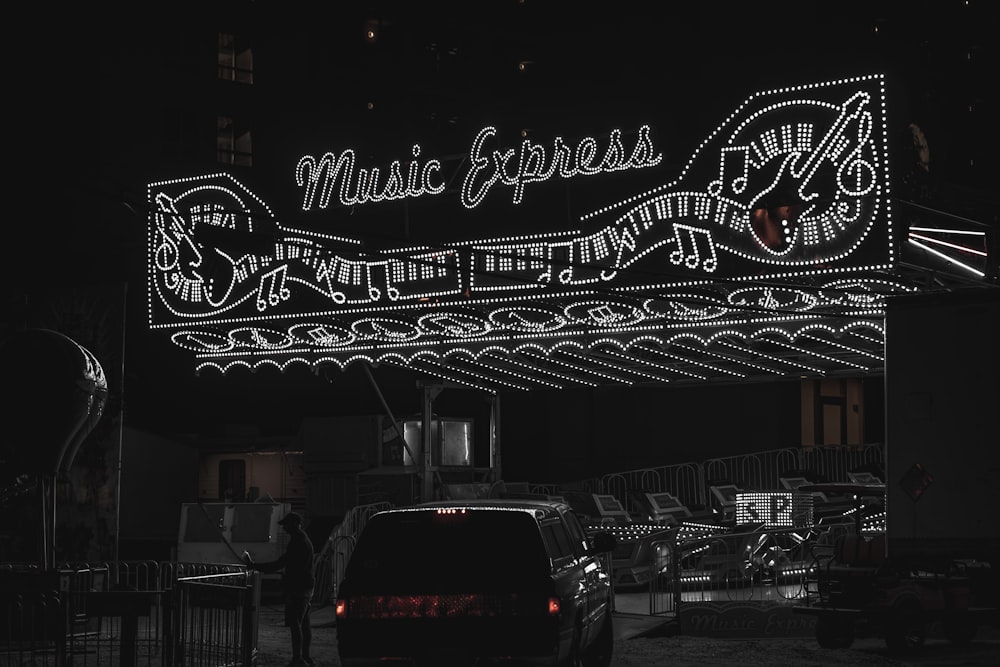 a black and white photo of a neon sign