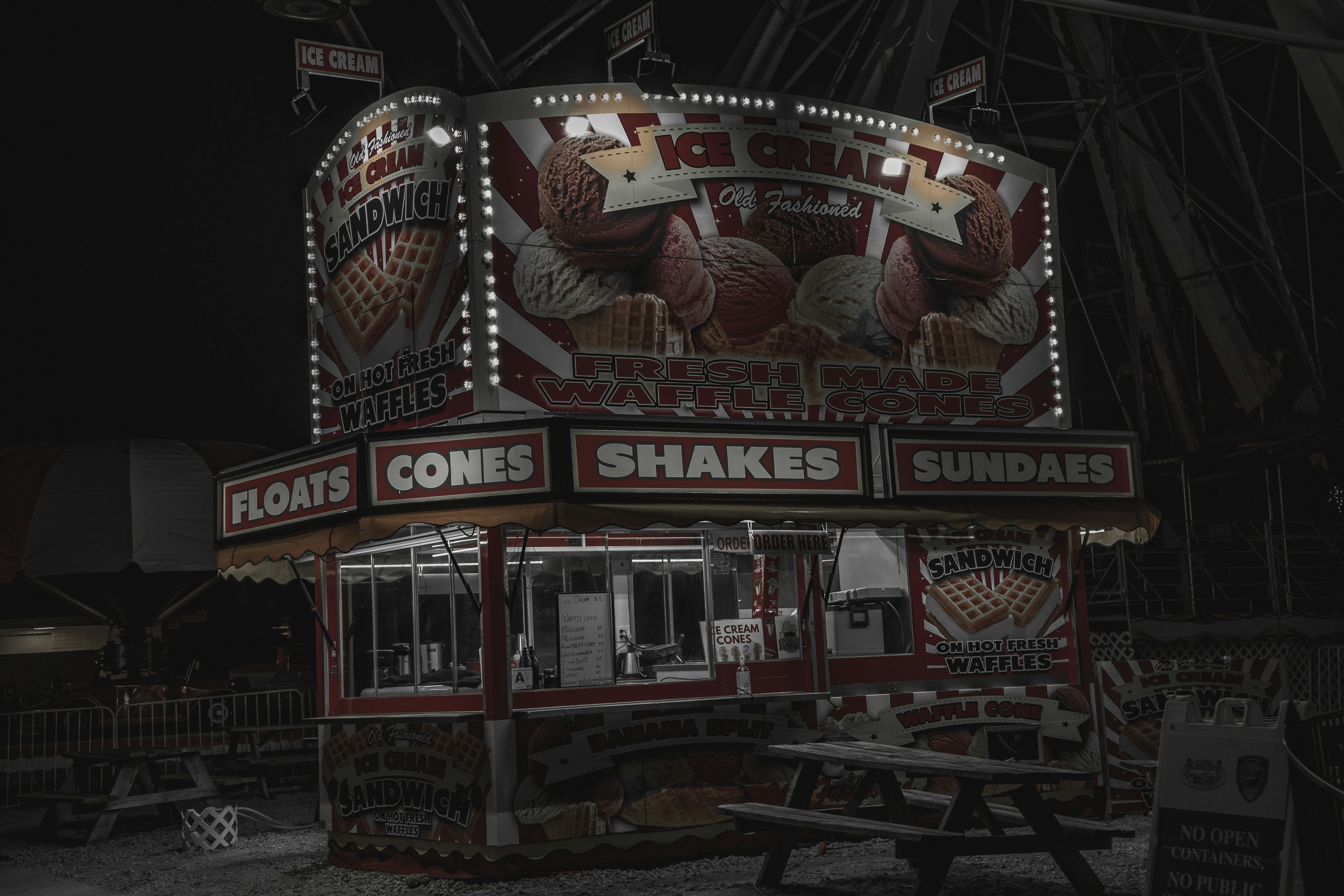 a dark picture of a food stand at night