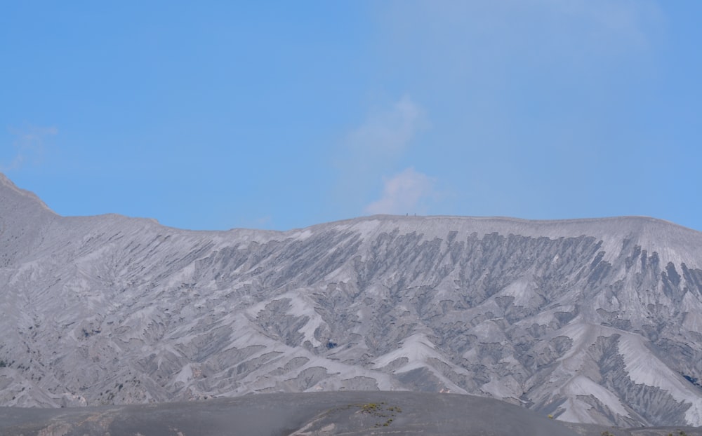 a view of a mountain range from the top of a hill