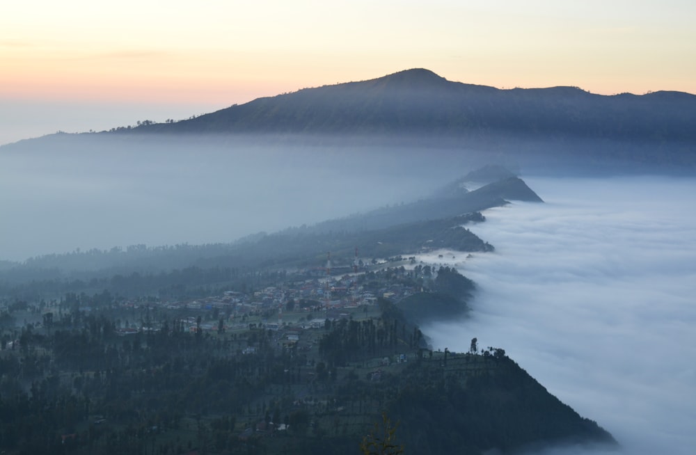 a view of a mountain covered in fog