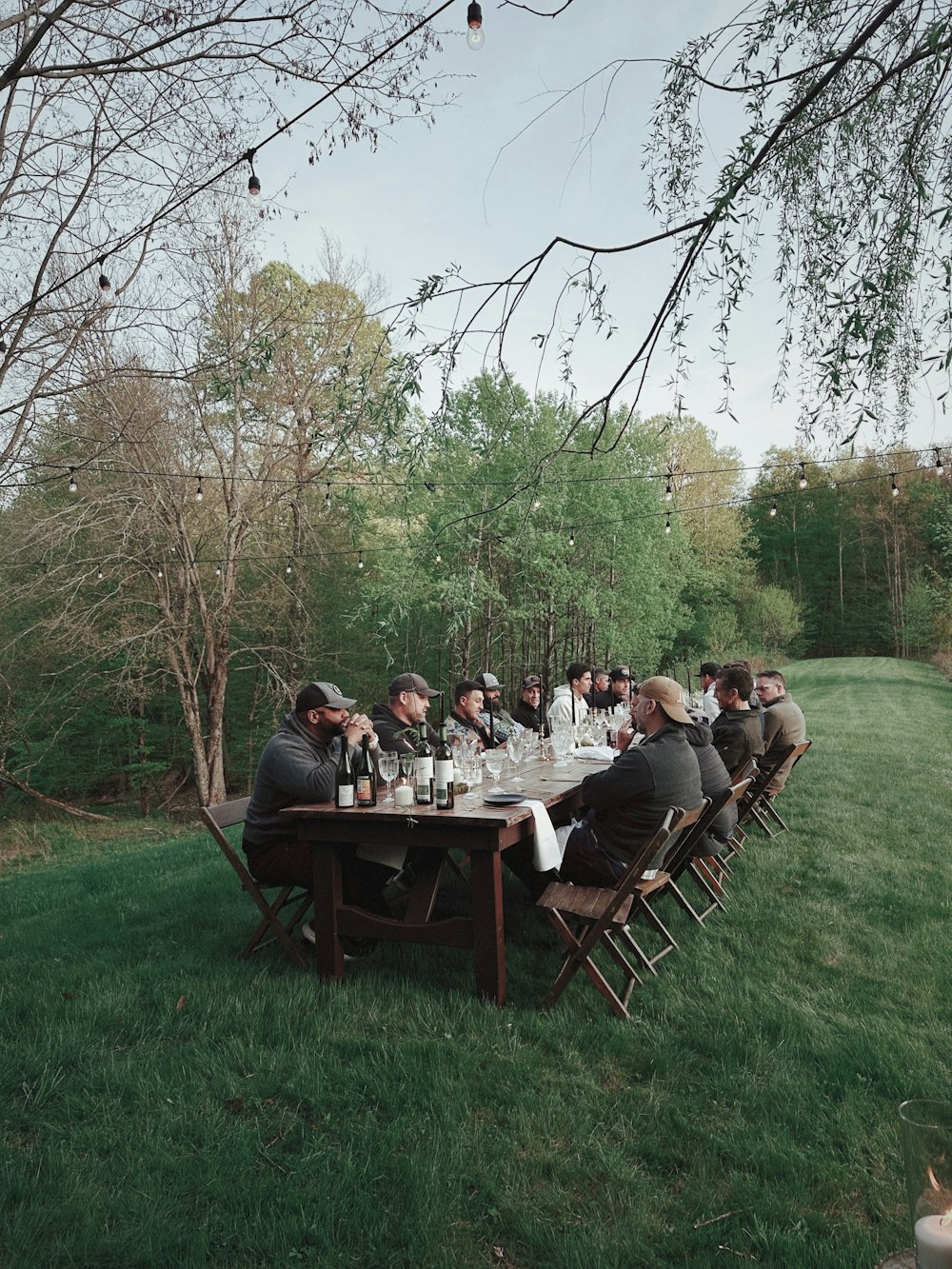 a group of people sitting at a table outside