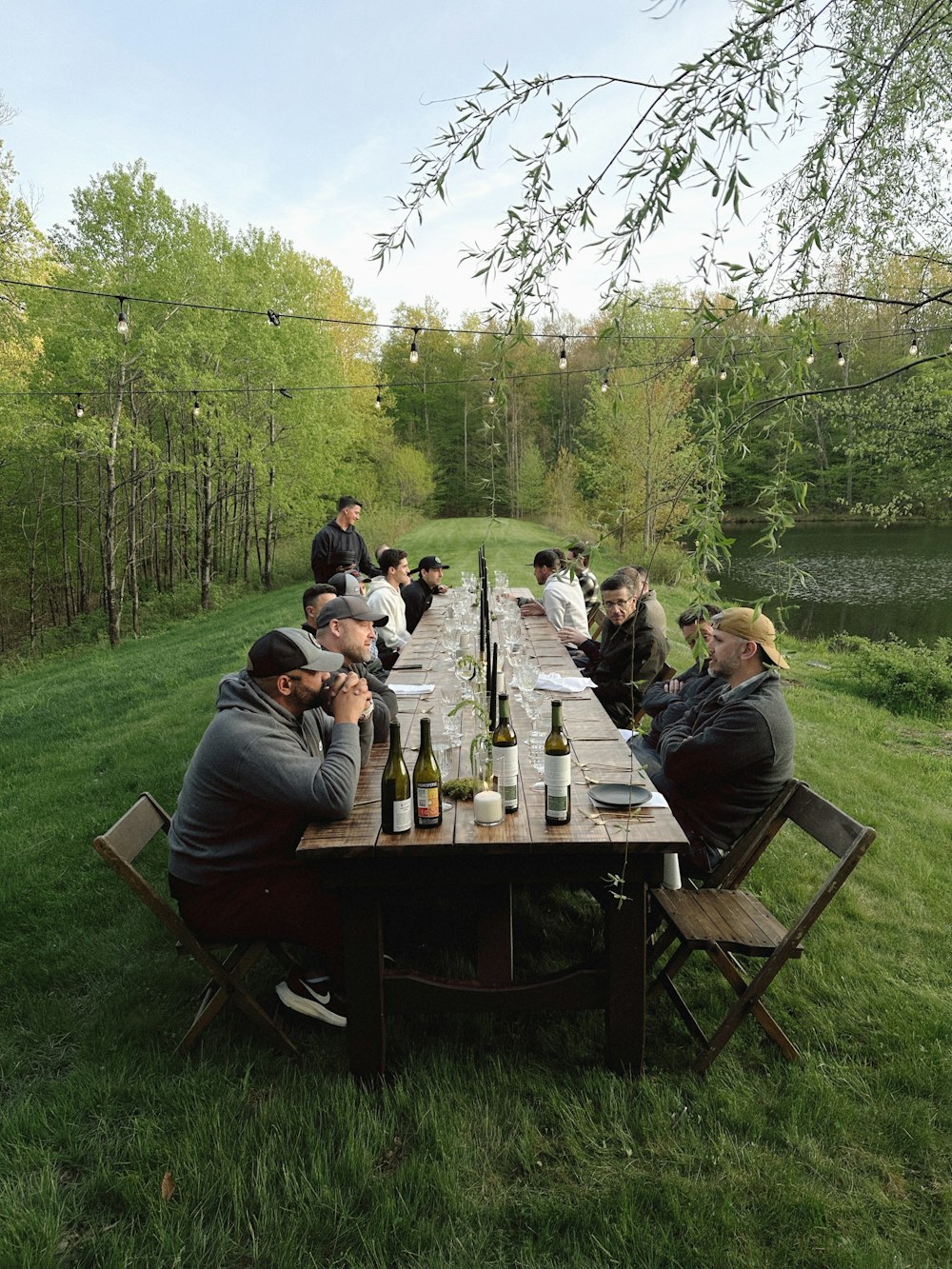 a group of people sitting at a picnic table