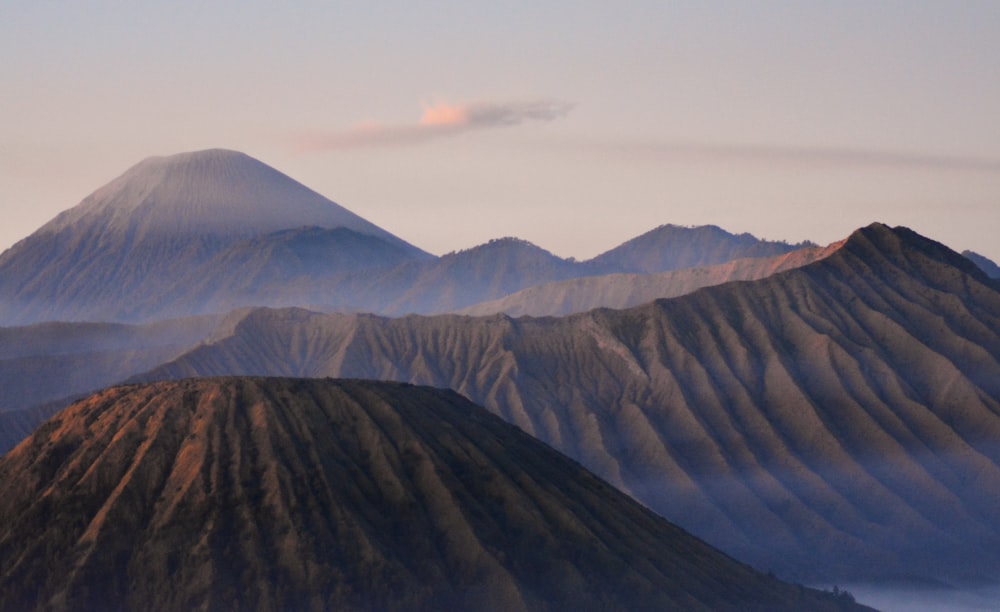 a view of a mountain range with a cloud in the sky