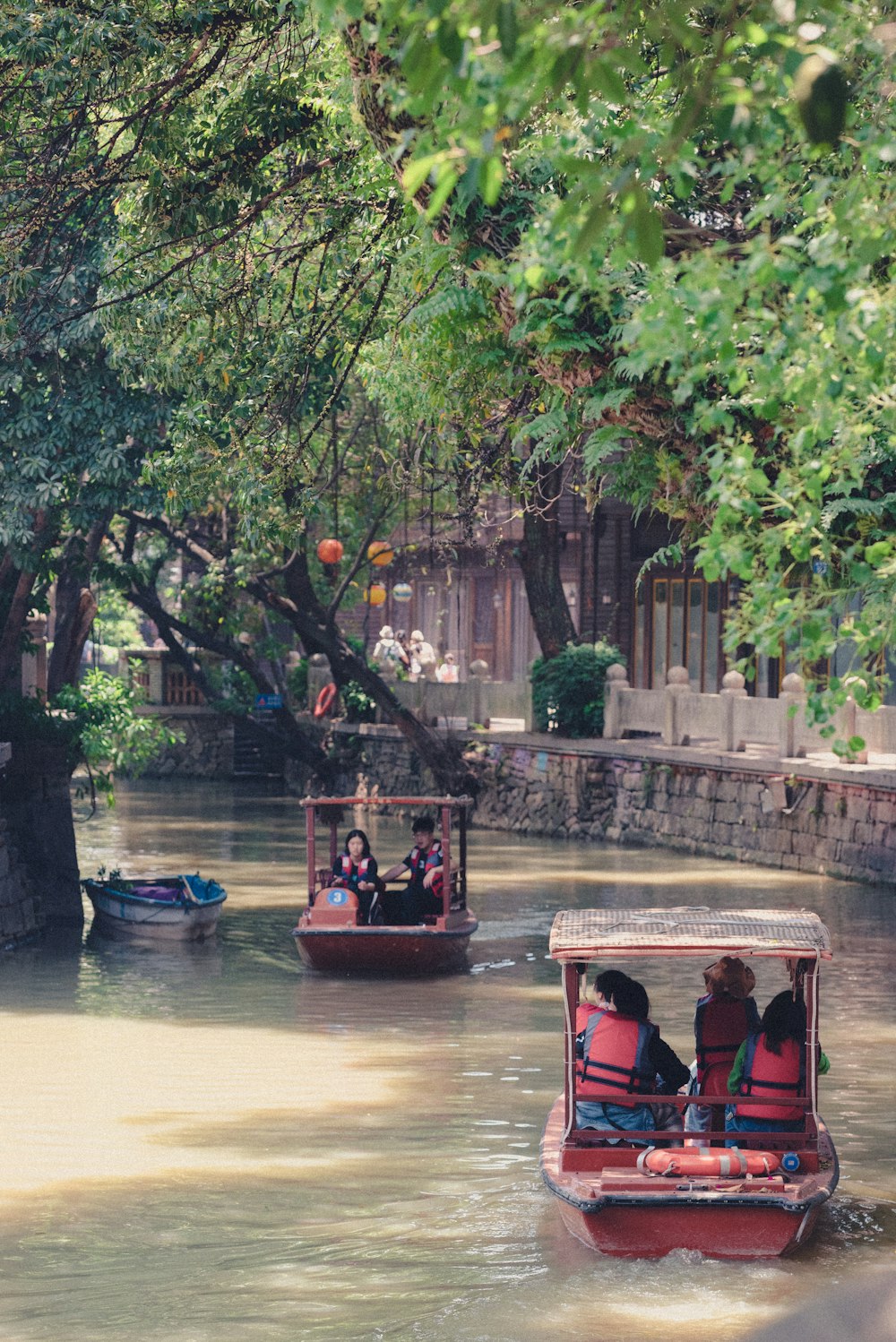 a group of people riding in a boat down a river