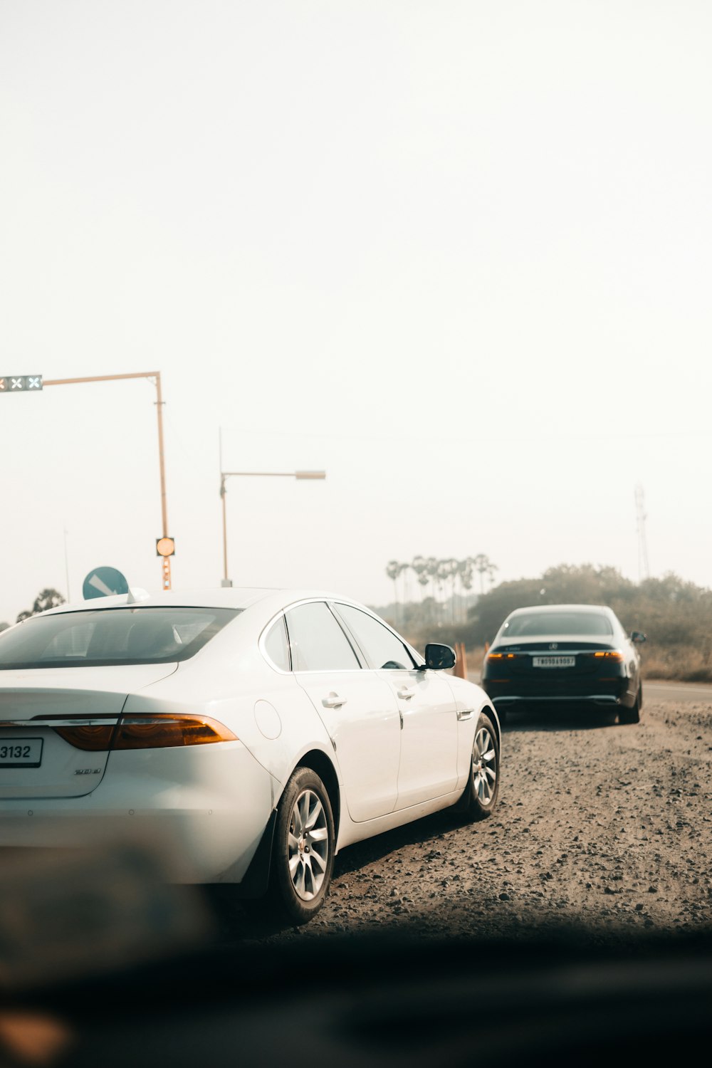 a couple of cars that are sitting in the dirt