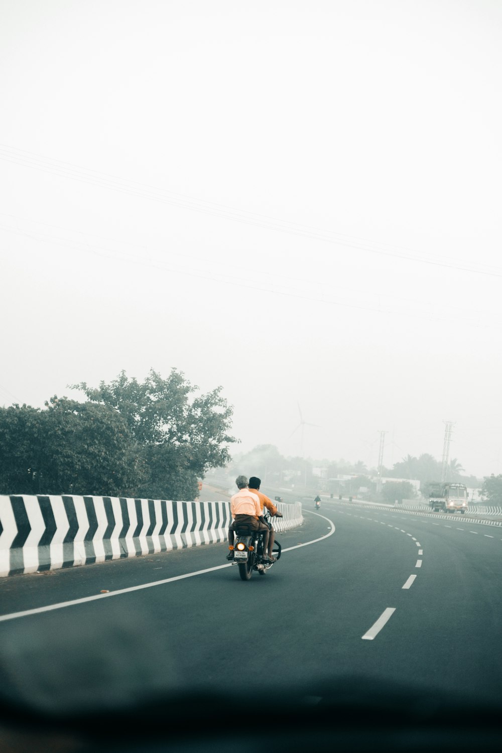 a man riding a motorcycle down a curvy road