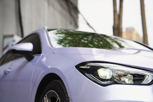 A close-up of a sleek car mirror reflecting light.