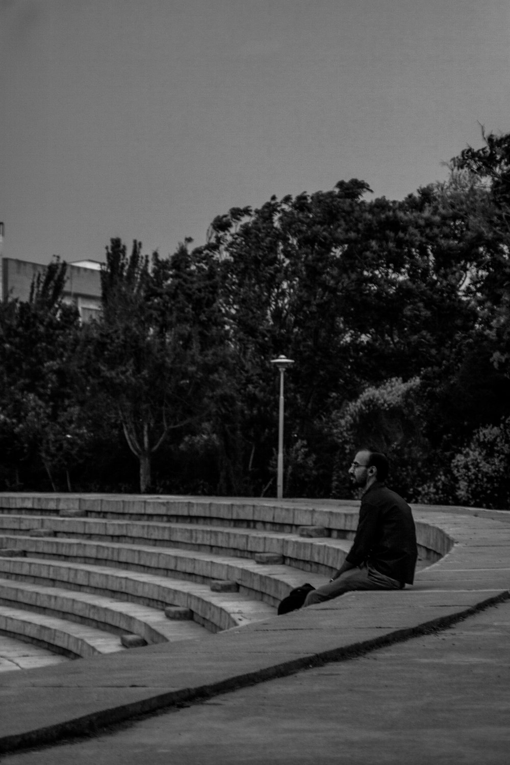 a man sitting on the steps of a building