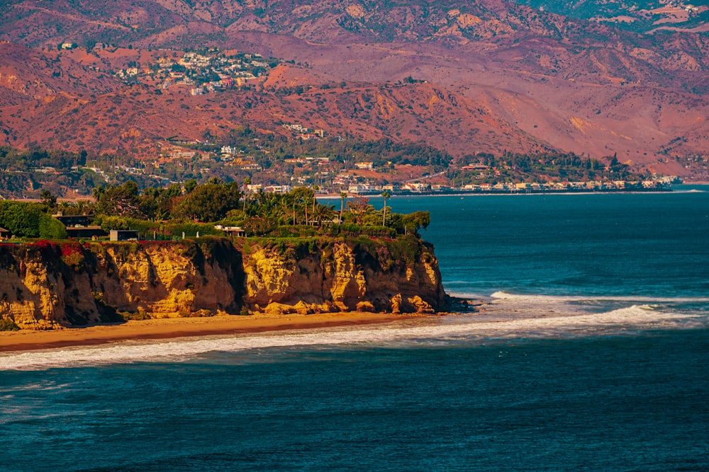 a large body of water with a mountain in the background