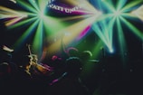 An immersive event with colorful lighting and engaged audience members.