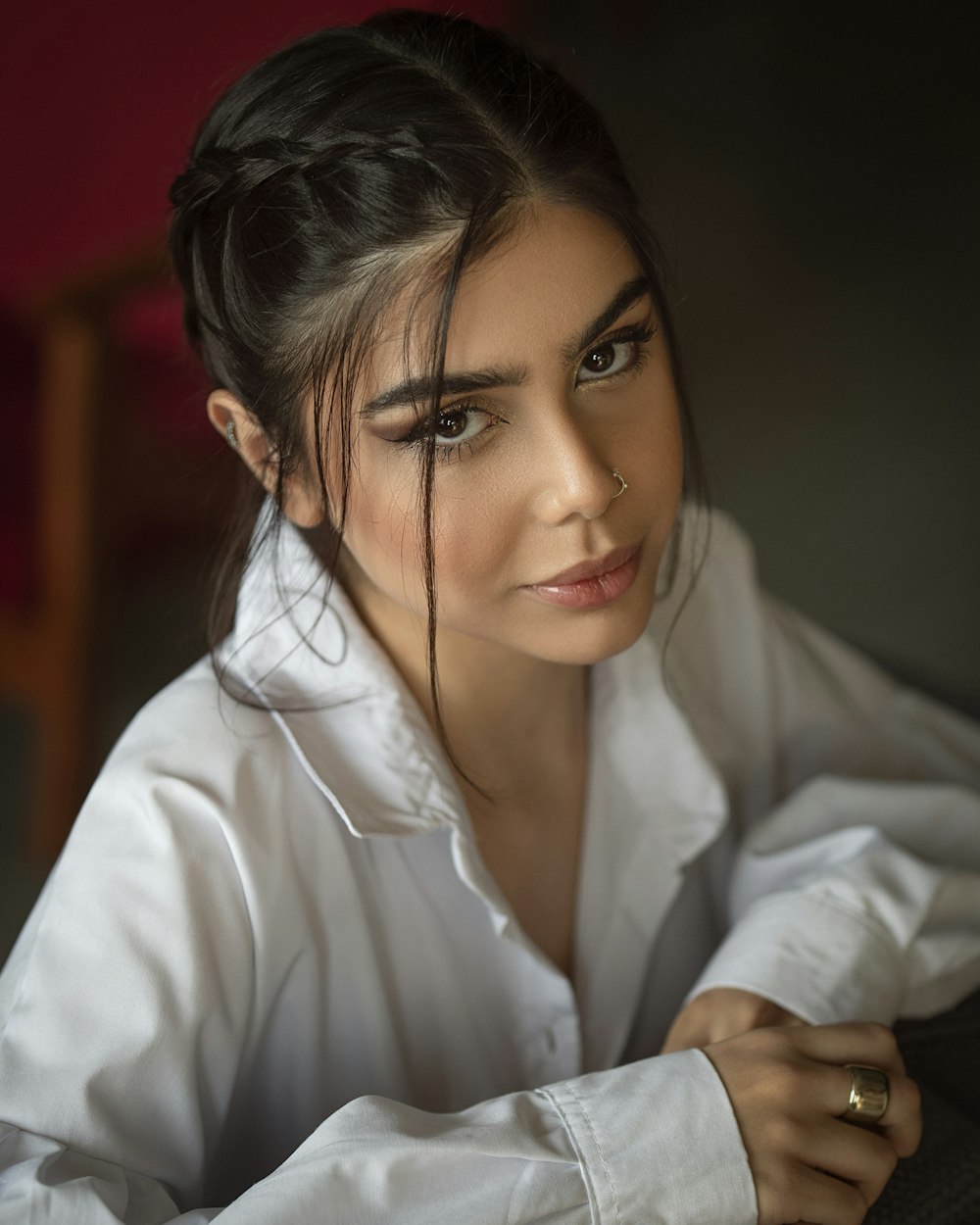 a woman in a white shirt is posing for a picture