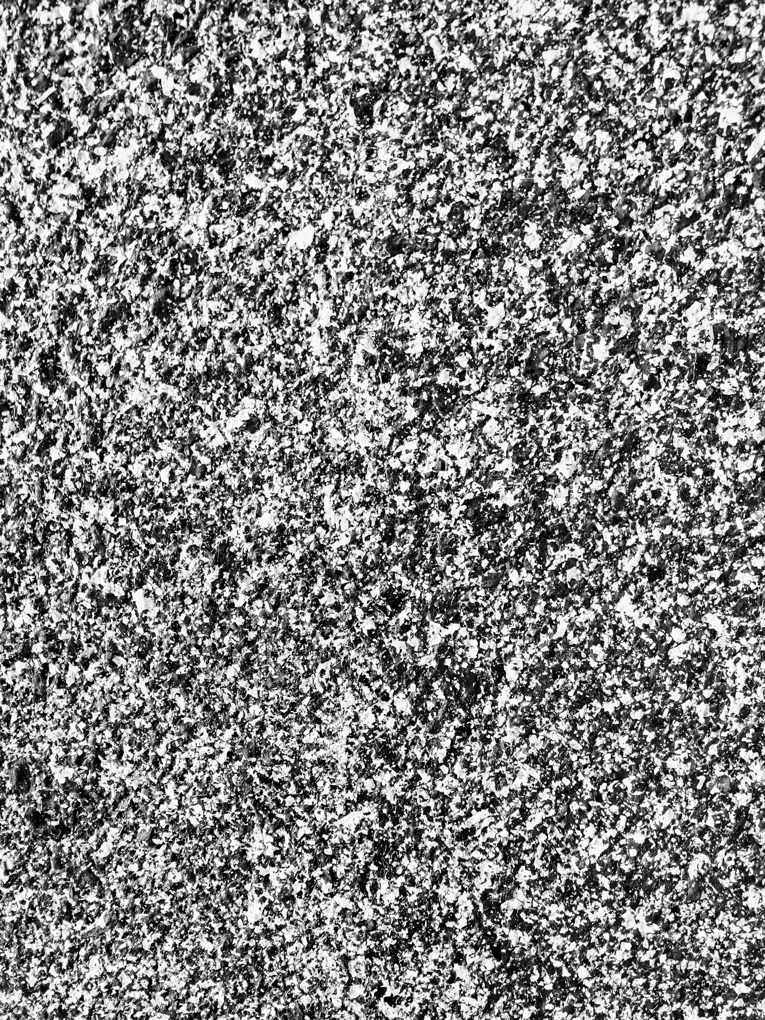 A detailed texture of a granite surface with a speckled pattern of gray, black, and white colors.