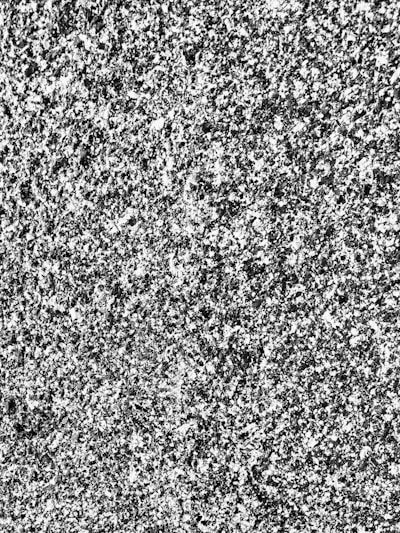 A detailed 3D rendering of a granite block with precise measurement overlays in a sleek app interface.